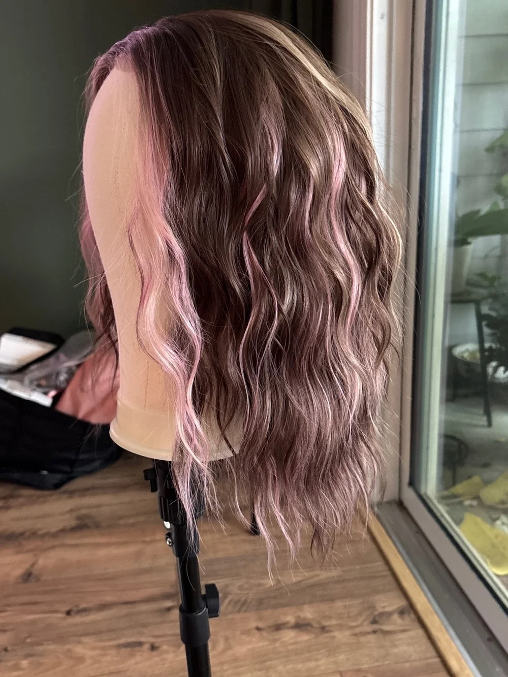 Carkira brown with pink face framing highlights. Petite but fits standard.